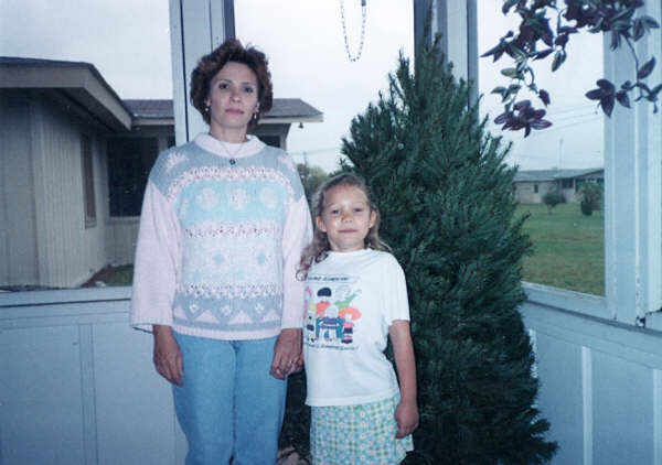 The author at age 7. “I’m standing next to my mom with our not-yet-decorated Christmas tree in the sun room of our Florida home,” she writes.