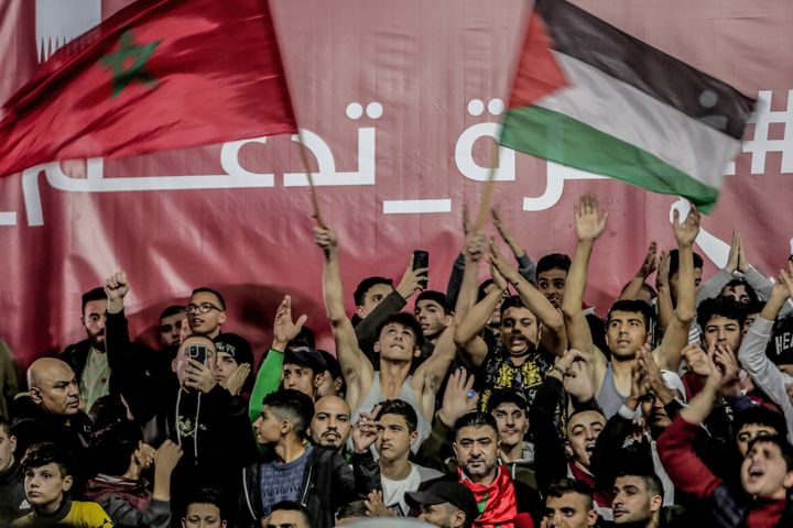 Palestinians in Gaza wave Morocco and their national flags as they watch a live broadcast of the World Cup quarterfinal match between Morocco and Portugal held in Qatar. (Final score; Morocco 1-0 Portugal).