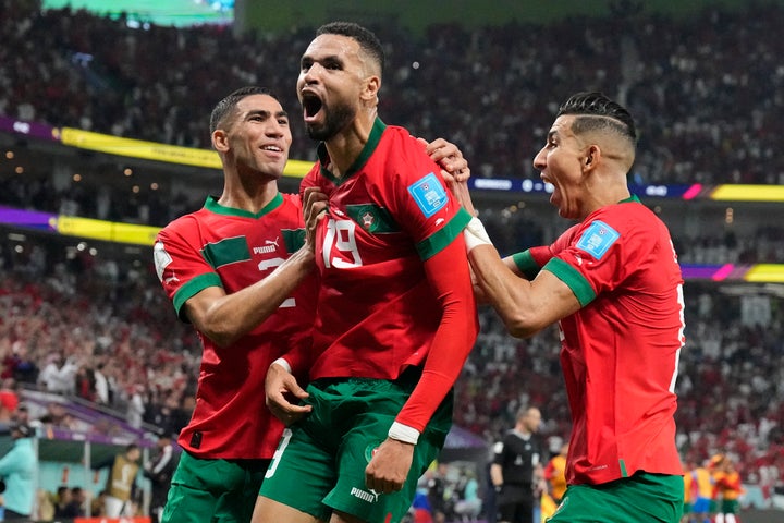 Morocco's Youssef En-Nesyri, center, celebrates after scoring his side's first goal during the World Cup quarterfinal soccer match between Morocco and Portugal, at Al Thumama Stadium in Doha, Qatar, Saturday, Dec. 10, 2022.