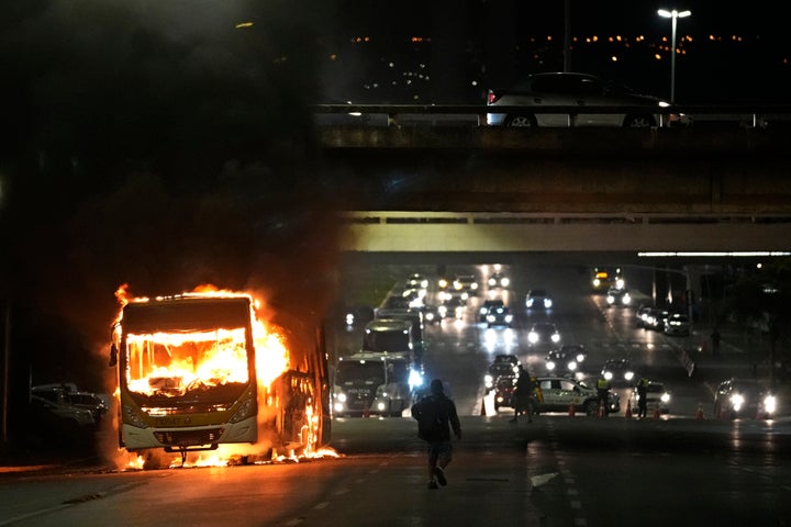 Supporters of Brazilian President Jair Bolsonaro clash with police setting fire to several vehicles and allegedly trying to storm the headquarters of the Federal Police in Brasilia, Brazil, on Dec. 12, 2022.