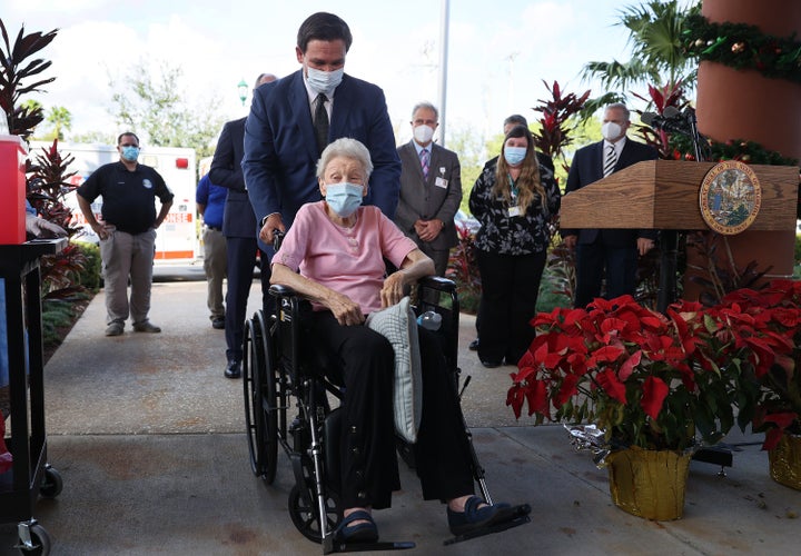 Florida Gov. Ron DeSantis pushes Vera Leip, 88, in her wheelchair after she received a Pfizer-BioNtech COVID-19 vaccine at the John Knox Village Continuing Care Retirement Community on Dec. 16, 2020 in Pompano Beach, Florida. The facility, one of the first in the country to do so, vaccinated approximately 170 people including healthcare workers and elder care people. 