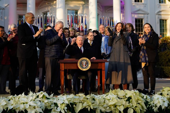 President Joe Biden raise his pen and reacts to applauds after signing the Respect for Marriage Act, Tuesday, Dec. 13, 2022, on the South Lawn of the White House in Washington. (AP Photo/Patrick Semansky)
