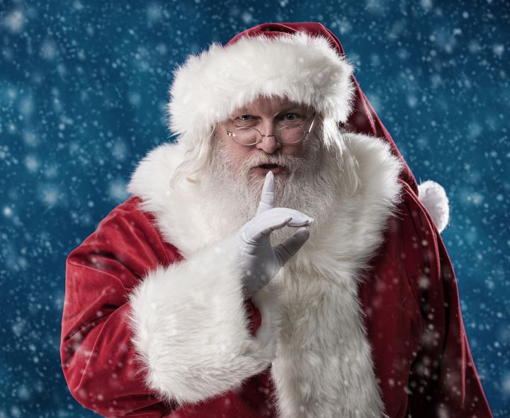 Shhhh: Santa stands outside in the falling snow with his finger to his lips, telling you to be quiet and keep his secret.