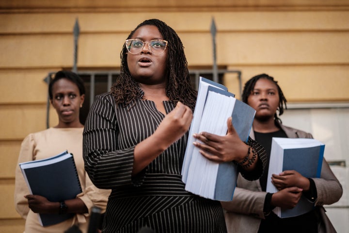 Kenyan lawyer Mercy Mutemi (center) addresses the press after filing the lawsuit.