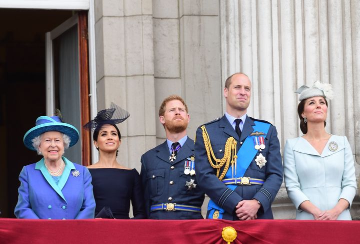 (L-R) Queen Elizabeth II, the Duchess of Sussex, Duke of Sussex, and the Duke and Duchess of Cambridge (now the Prince and Princess of Wales) watching the RAF 100th anniversary flypast from the balcony of Buckingham Palace.