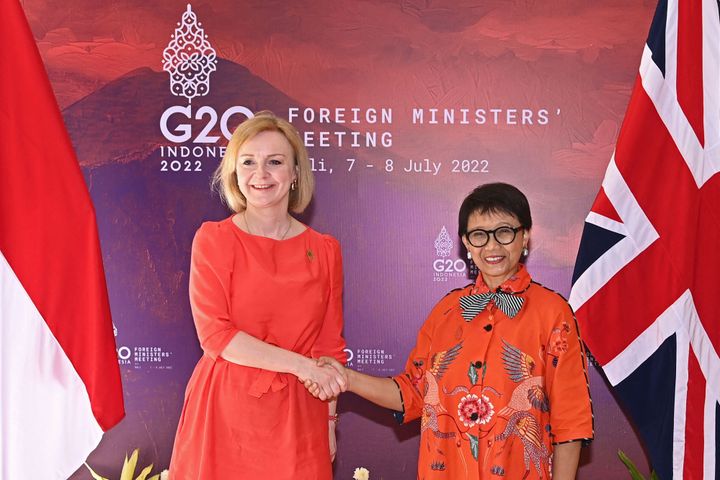 Indonesia's Foreign Minister Retno Marsudi (R) shakes hands with Liz Truss at the G20 Foreign Ministers Meeting in Nusa Dua on Bali 