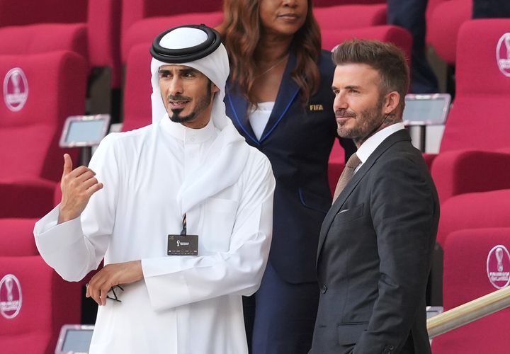 David Beckham (right) in the stands before the FIFA World Cup Group B match at the Khalifa International Stadium in Doha, Qatar. 