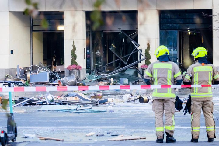 Firefighters stand in front of debris after a huge aquarium burst at the Sea Life Aquarium on Friday. The cause of the aquarium burst is still under investigation, German police said.