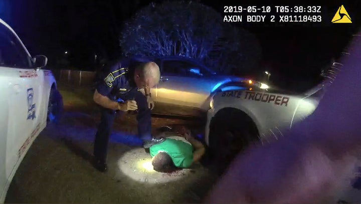 This image from video from Louisiana state police state trooper Dakota DeMoss' body-worn camera shows trooper Kory York bending over with his foot on Ronald Greene's shoulder after he was taken into custody.