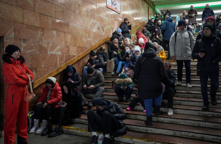 People rest in a subway station being used as a bomb shelter during a rocket attack in Kyiv, Ukraine, on Dec. 16, 2022.