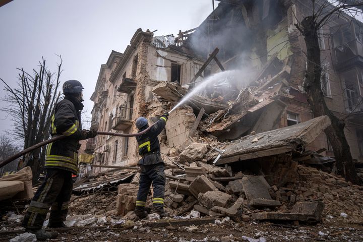 Firefighters from Ukraine's State Emergency Service work on December 16 to put out a fire at a building in Kryvyi Rih.