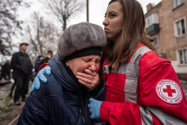 A woman cries in front of the building destroyed in Kryvyi Rih.