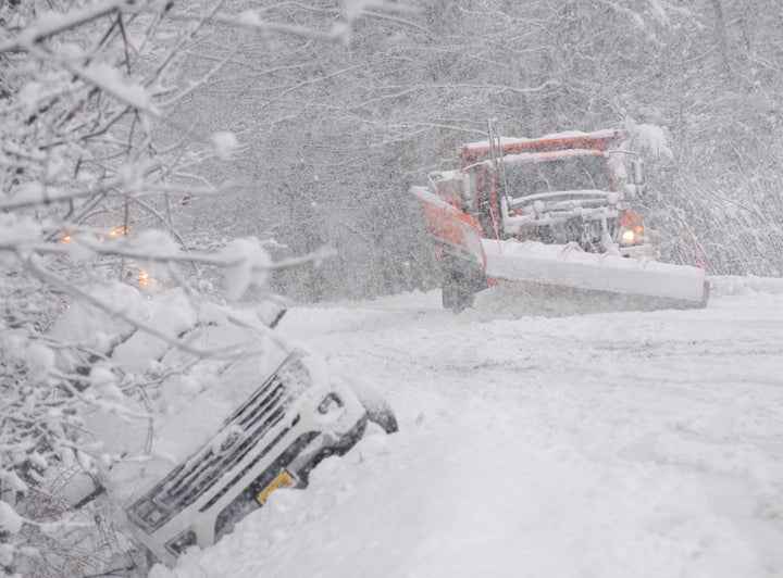 A state plow truck clears the snow along Route 30 in Jamaica, Vt., during a snowstorm on Friday, Dec. 16, 2022. (Kristopher Radder/The Brattleboro Reformer via AP)