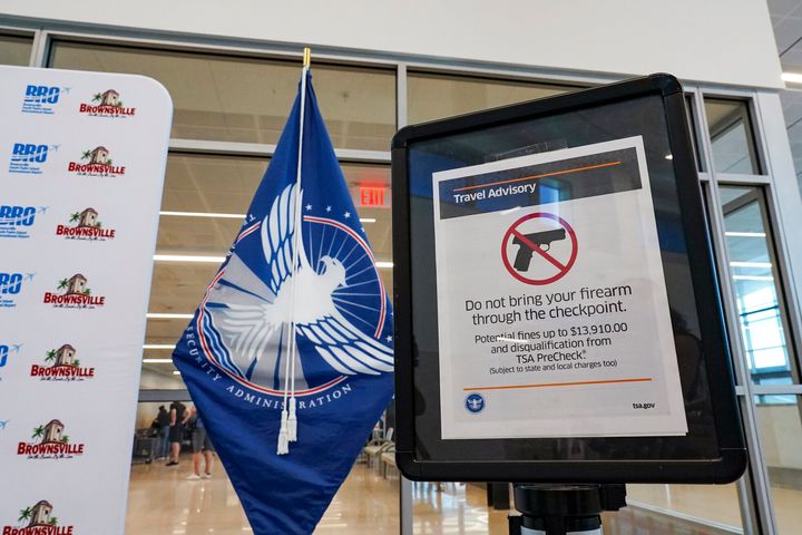 FILE - A sign advises airline travelers not to bring their firearm through the Transportation Security Administration checkpoint on, July 28, 2022, during a media event about traveling with firearms at the Brownsville-South Padre Island International Airport in Brownsville, Texas. The TSA said Friday, Dec. 16, 2022, it is raising the fine for people caught with a gun in their carry-on bag to a maximum fine to $14,950 after intercepting a record number of firearms at security checkpoints this year. Previously it was $13,910. (Denise Cathey/The Brownsville Herald via AP, File)