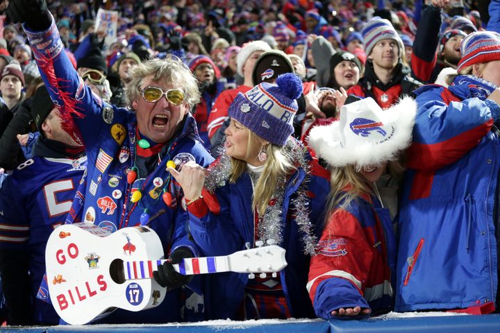 Buffalo Bills fans celebrate a touchdown during the first half of an NFL football game against the Miami Dolphins in Orchard Park, New York on Saturday.