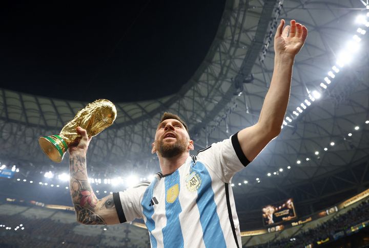 Soccer Football - FIFA World Cup Qatar 2022 - Final - Argentina v France - Lusail Stadium, Lusail, Qatar - December 18, 2022 Argentina's Lionel Messi celebrates winning the World Cup with the trophy REUTERS/Hannah Mckay