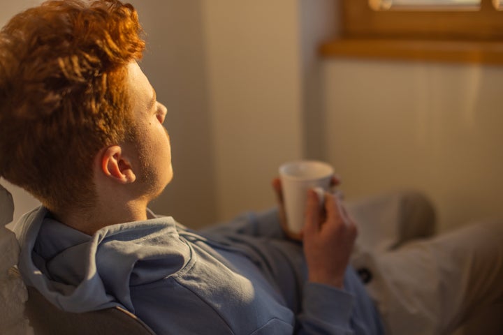 Teenage Caucasian boy drinking coffee