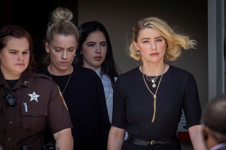 Heard is seen exiting the courthouse beside her sister, Whitney Heard, in June. Heard said Monday that her settlement with Depp "is not an act of concession."