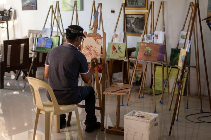 Filipino artist Elito Circa, 52, paints with his own blood in his studio in Nueva Ecija province, Philippines November 29, 2022. REUTERS/Eloisa Lopez