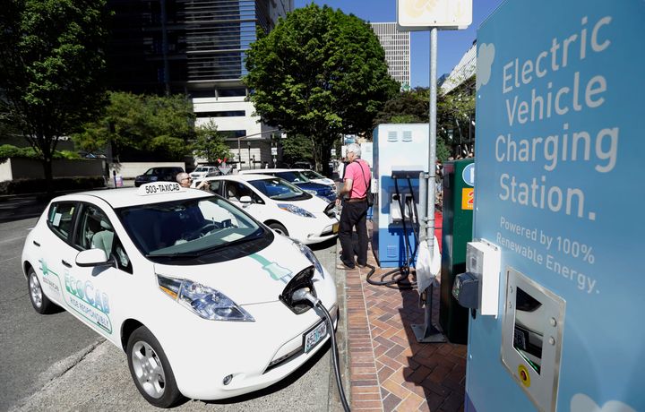 A line of electric cars and charging stations sit in front of the Portland General Electric headquarters building in Portland, Oregon, on July 28, 2015.