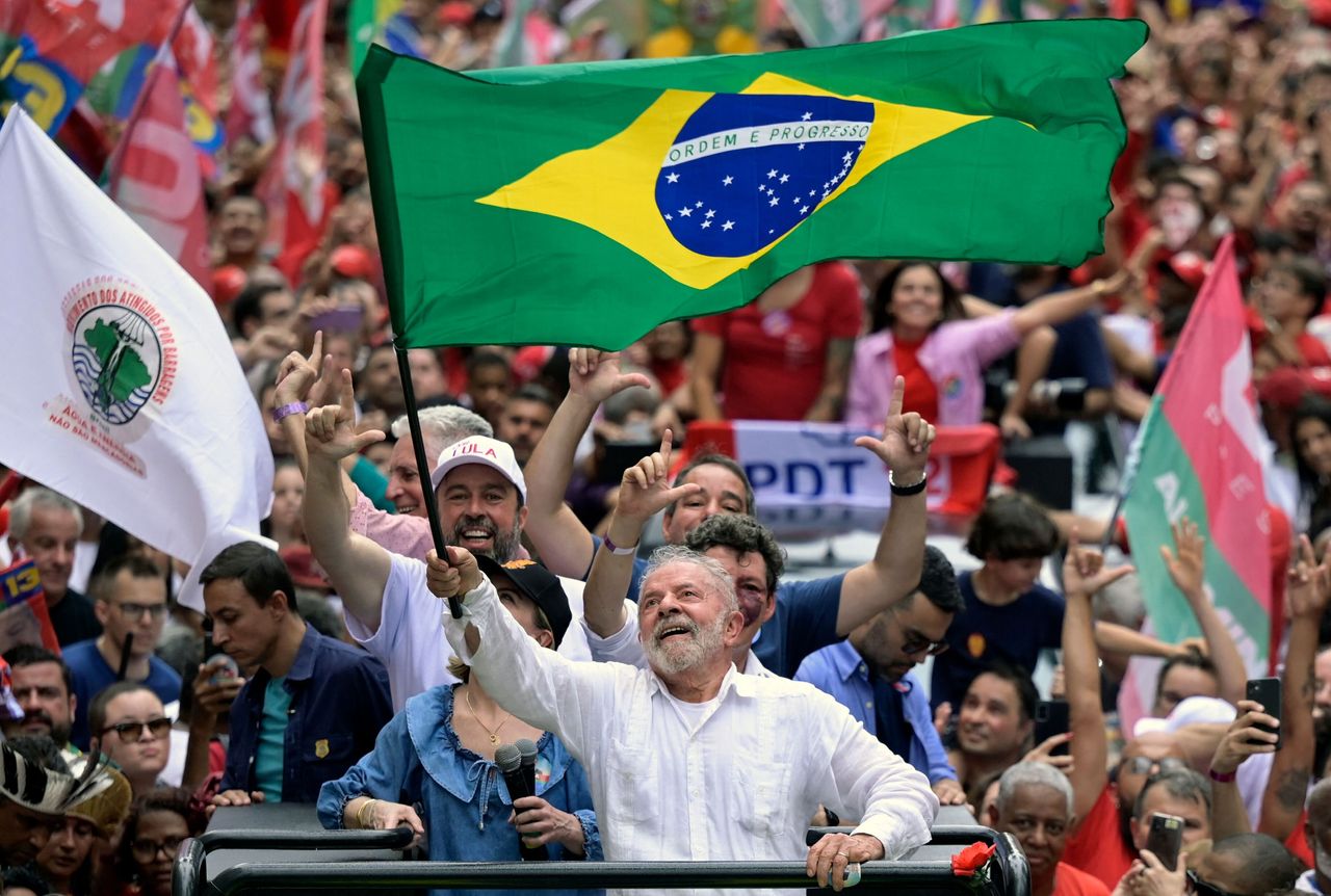 Luiz Inacio Lula da Silva waves a national flag during a campaign rally in Belo Horizonte, Minas Gerais state, Brazil on Oct. 9.
