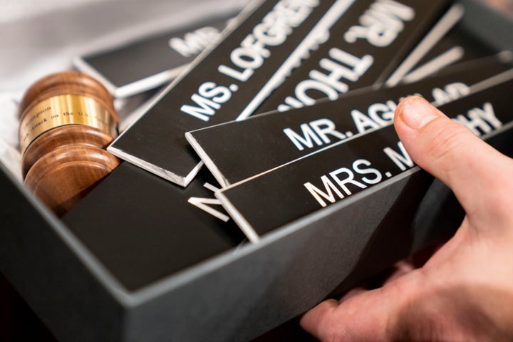 An aide boxes up the nameplates for the committee members and the chairman's gavel after the House select committee investigating the Jan. 6 attack on the U.S. Capitol held its final meeting on Capitol Hill in Washington on Monday.