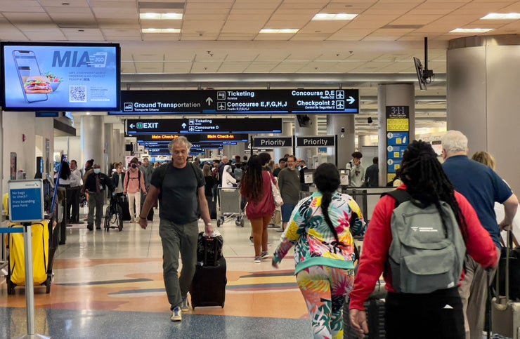 Travelers transit through Miami International Airport in Miami, Florida, on April 22, 2022. The U.S. government is appealing a court ruling that controversially lifted a federal mask mandate on public transport earlier this week, the Justice Department said on April 20. After the Centers for Disease Control and Prevention (CDC) assessed that masks remain "necessary to protect the public health, the Department has filed a notice of appeal," spokesman Anthony Coley said. A federal judge on April 18 struck down the COVID mask mandate, stating that it exceeded the CDC's statutory authority.