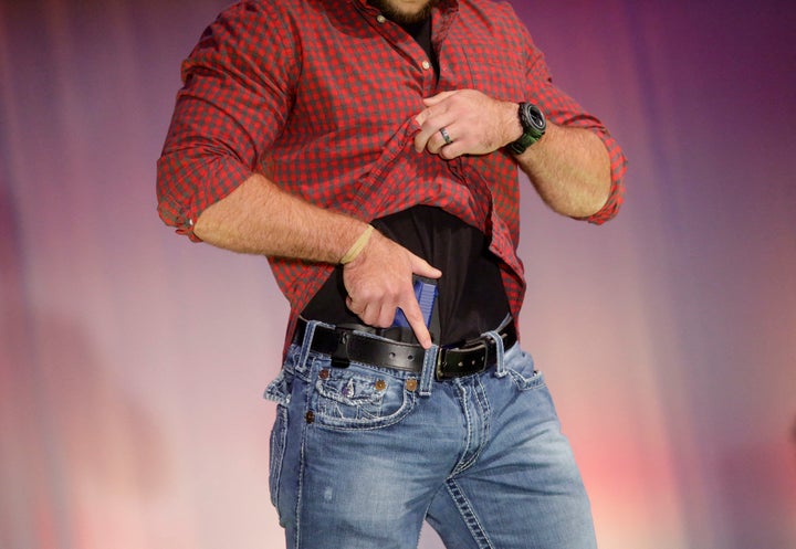 A model walks the runway during the NRA Concealed Carry Fashion Show on Friday, Aug. 25, 2017, in Milwaukee, Wisconsin. Half of America’s 50 states now allow people to carry handguns without first seeking a permit. 