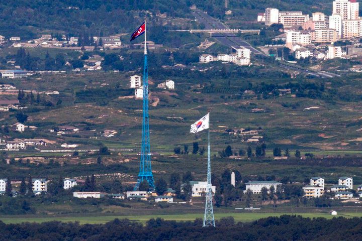 Flags of North Korea, rear, and South Korea, front, flutter in the wind as pictured from the border area between two Koreas in Paju, South Korea, on Aug. 9, 2021. South Korea’s Joint Chiefs of Staff said North Korea fired a ballistic missile toward its eastern waters on Dec. 23, 2022.