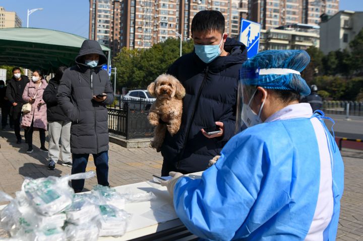 A medical worker distributes free health kit packages for Covid prevention and control at a community health centre on December 23, 2022 in China