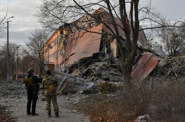 Police officers check a school that was damaged in Russian shelling in Kramatorsk, Ukraine, on Dec. 22, 2022. 