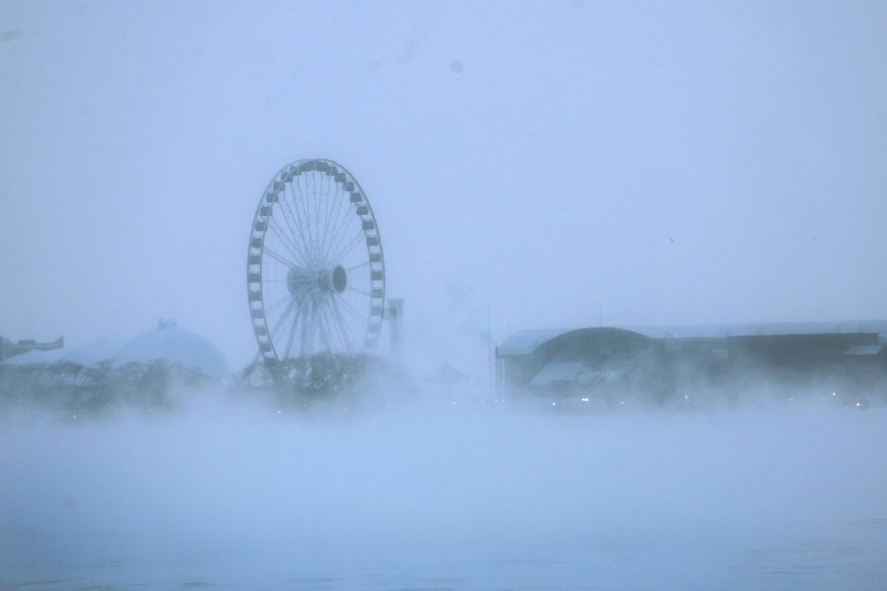 Vapor rises off Lake Michigan on Friday, obscuring Chicago's Centennial Wheel. Temperatures hovered around -8 degrees. Wind chill temperatures may dip as low as -40 degrees overnight.
