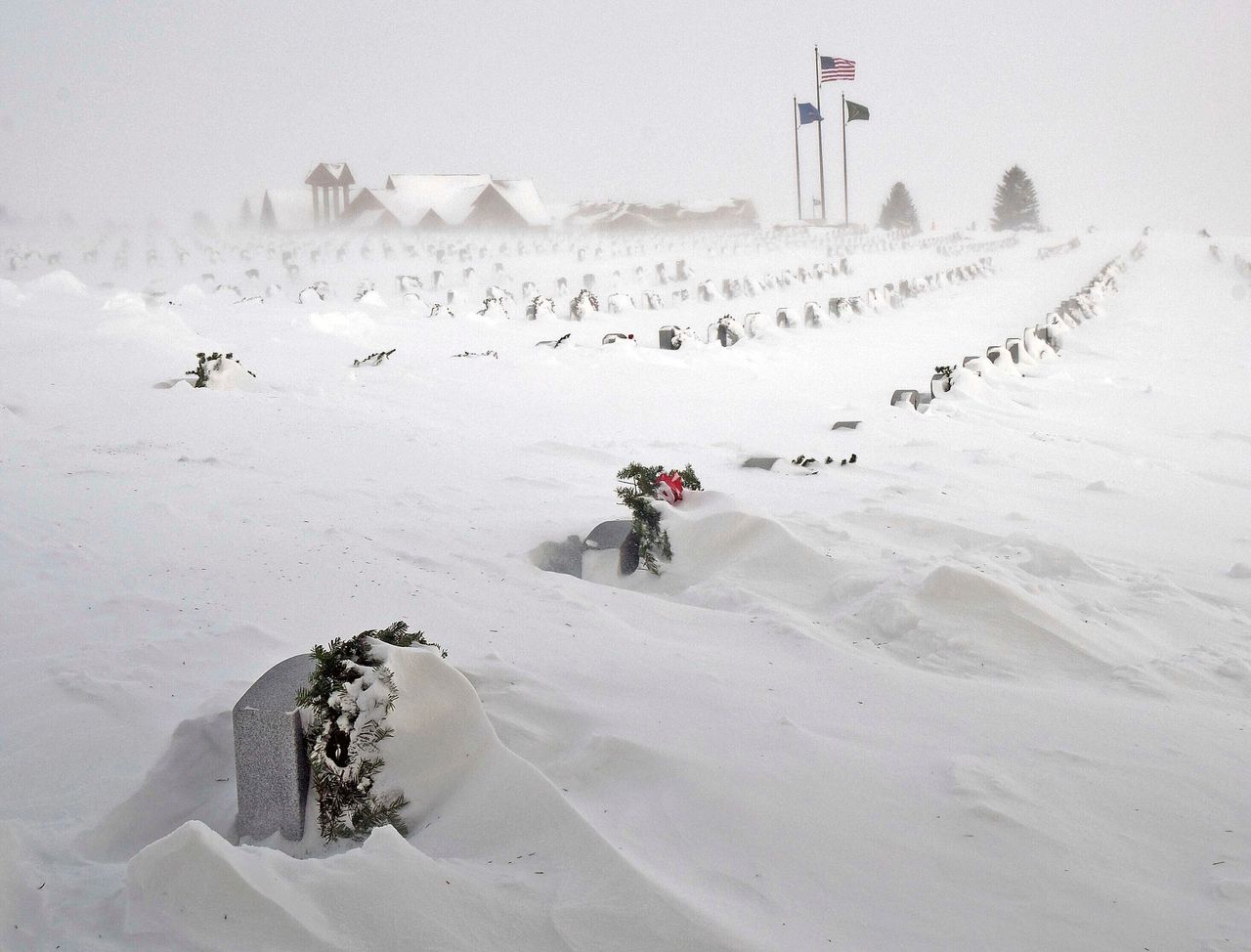 Rows of headstones at the North Dakota Veterans Cemetery are blanketed by snow Thursday.