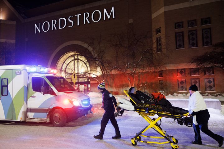 Two first responders and an ambulance are seen at the entrance to the Nordstrom at the Mall of America after reports of shots fired Friday.