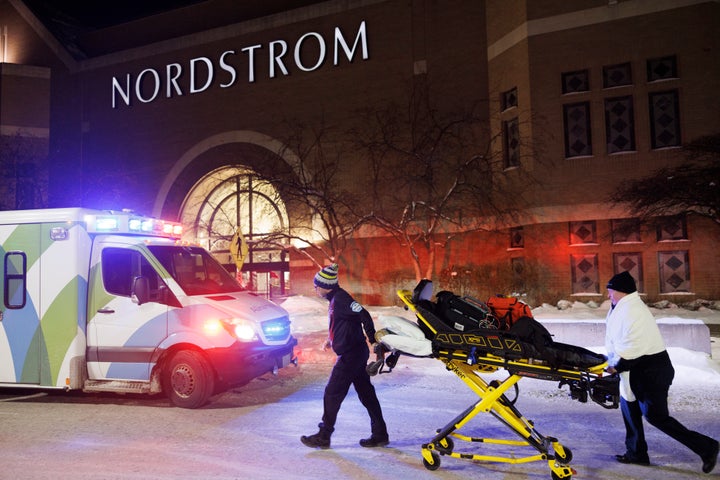 Two first responders and an ambulance are seen at the entrance to the Nordstrom at the Mall of America after reports of shots fired Friday.