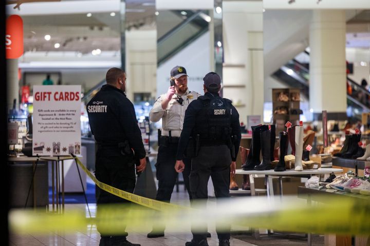 Security officers speak inside a store at the Mall of America in Bloomington, Minnesota after reports of shots fired on Friday.