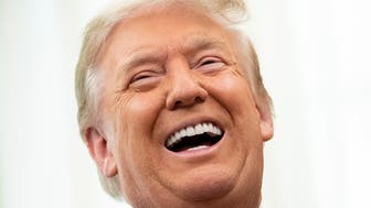 US President Donald Trump laughs during a Medal of Freedom ceremony for Lou Holtz in the Oval Office of the White House on December 3, 2020, in Washington, DC. (Photo by Brendan Smialowski / AFP) (Photo by BRENDAN SMIALOWSKI/AFP via Getty Images)
