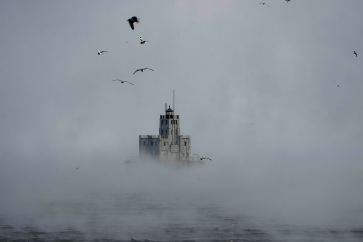 Steam rises off of Lake Michigan as morning temperatures remain below zero with heavy winds on Friday in Milwaukee. Winter weather is blanketing the U.S. as a massive storm sent temperatures crashing and created whiteout conditions.
