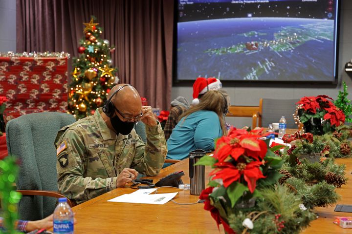 In this photo released by the U.S. Department of Defense, volunteers answer phones and emails from children around the globe during annual NORAD Tracks Santa event at Peterson Air Force Base in Colorado Springs, Colorado on Christmas Eve in 2021.