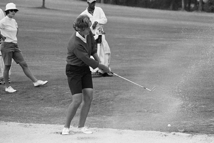 CORRECTS DATE TO SATURDAY, DEC. 24, 2022, NOT SATURDAY, DEC. 25, 2022. - FILE - Kathy Whitworth of San Antonio, blast out of sand trap on 18th green and then sinks a 6-foot putt to go into the lead of the Women Titleholders Golf Tournament at Augusta, Ga., Nov. 25, 1966. Former LPGA Tour player Whitworth, whose 88 victories are the most by any golfer on a single professional tour, died on Saturday, Dec. 25, 2022, night, her longtime partner said. She was 83. (AP Photo/Horace Cort, File)