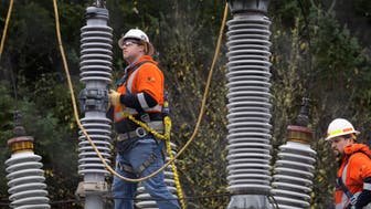 A Tacoma Power crew works at an electrical substation damaged by vandals early on Christmas morning, Sunday, Dec. 25, 2022, in Graham, Wa. (Ken Lambert/The Seattle Times via AP)
