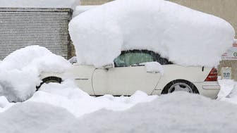A car is covered in snow after a snowfall Monday, Dec. 19, 2022 in Nagaoka, Niigata prefecture, northern Japan.(Kyodo News via AP)