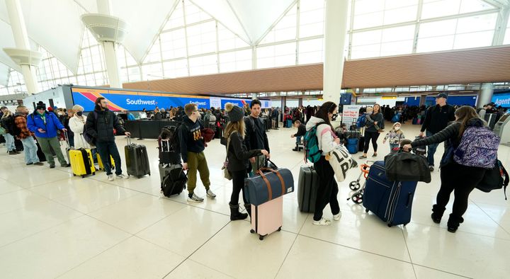 Travelers line up to check in at the Southwest Airlines counter in Denver International Airport.