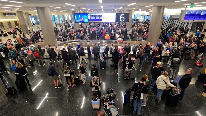 Travelers wait for their bags at Delta baggage claim Tuesday, Dec. 27, 2022, at Salt Lake City International Airport, in Salt Lake City. Many airlines were forced to cancel flights due to the weather, but Southwest was by far the most affected.