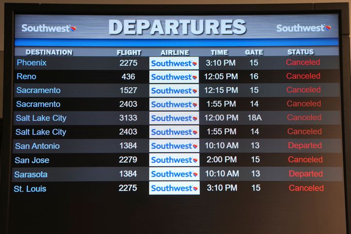 Canceled Southwest Airlines flights are seen in red on the departures flight schedules at the Southwest terminal at the Los Angeles International Airport, Tuesday, Dec. 27, 2022. The U.S. Department of Transportation says it will look into flight cancellations by Southwest that have left travelers stranded at airports across the country amid the intense winter storm. (AP Photo/Damian Dovarganes)