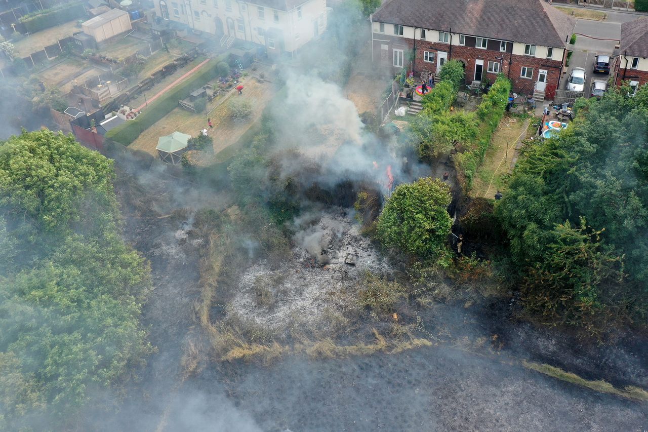 Firefighters containing a wildfire that encroached on homes in the Shiregreen area of Sheffield on July 20, 2022.