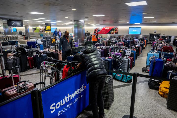 A traveler in Houston on Thursday looks over unclaimed luggage at the William P. Hobby Airport.