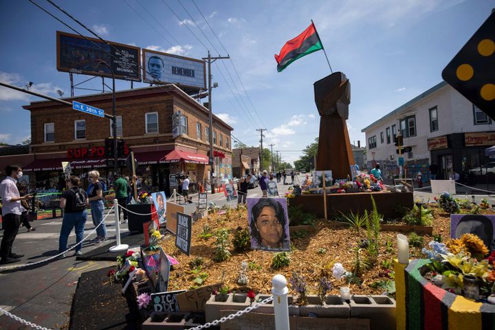 FILE – People walk through George Floyd Square on Tuesday, May 25, 2021, in Minneapolis. Justin Stetson, 34, faces one felony count of third-degree assault in connection with the May 30, 2020, beating of Jaleel Stallings. He would face up to five years in prison if convicted.