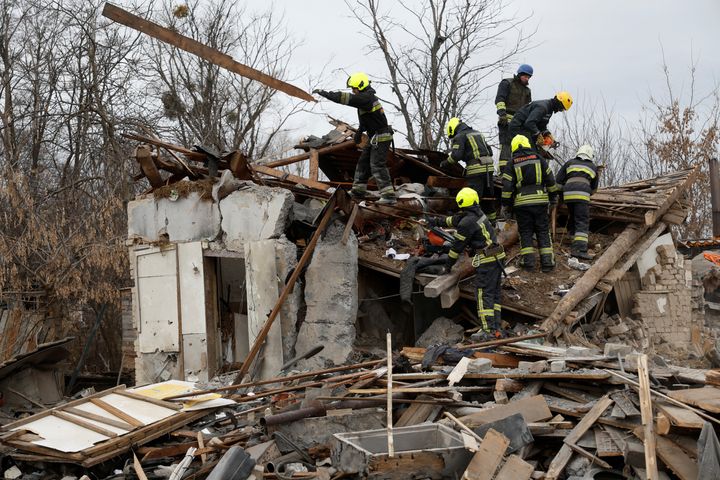 Rescuers work at a site of a residential house damaged during a Russian missile strike, amid Russia's attack on Ukraine, in Kyiv, Ukraine December 29, 2022. 