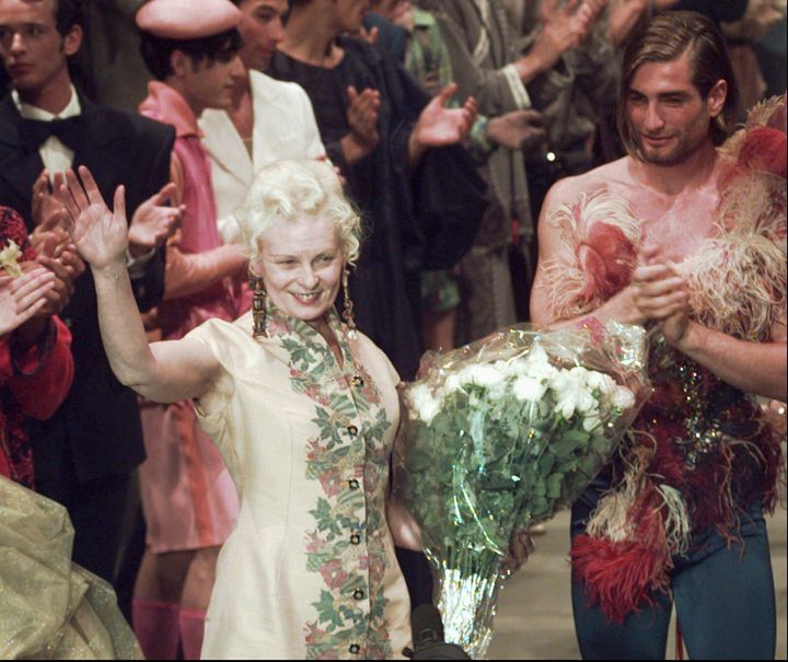 English designer Vivienne Westwood waves as she is applauded by her models at the end of the presentation of her Spring/Summer 1997 men's collection in Milan, Monday, July 1, 1996. (AP Photo/Luca Bruno)